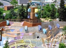 <a href="https://landscapearchitecturebuilt.com/zorlu-center">Zorlu Center</a>, <br>Istanbul, Turkey An image of landscape architecture project Zorlu Center, by design firms Carve & WATG, London, in Istanbul, Turkey. Showing a complex play structure with ropes, climbing walls, platforms and a large colorful slide.